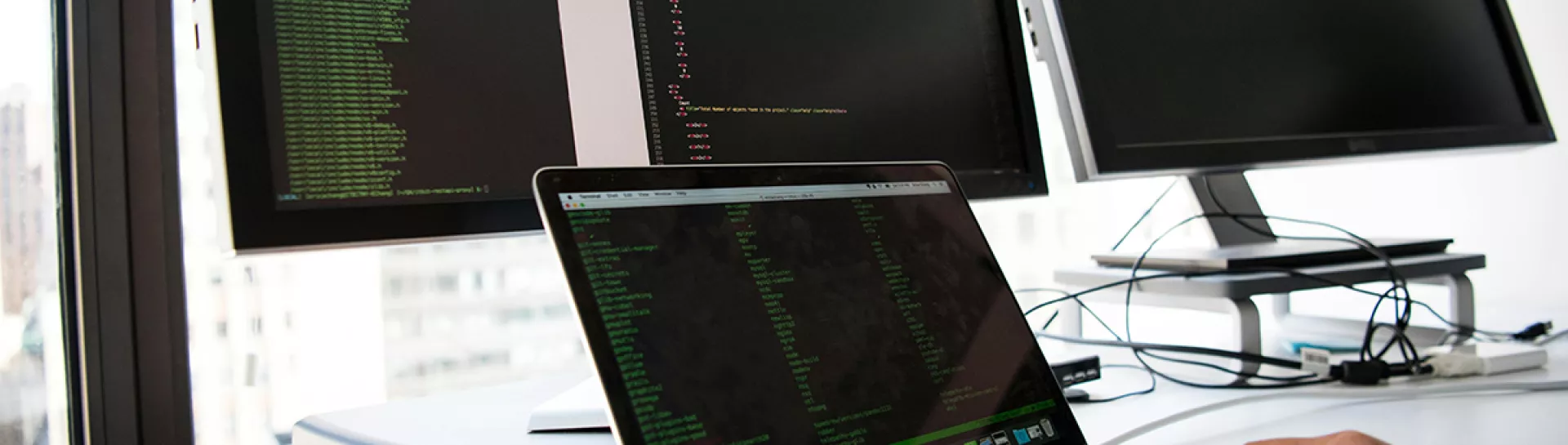 Person typing on laptop and coding