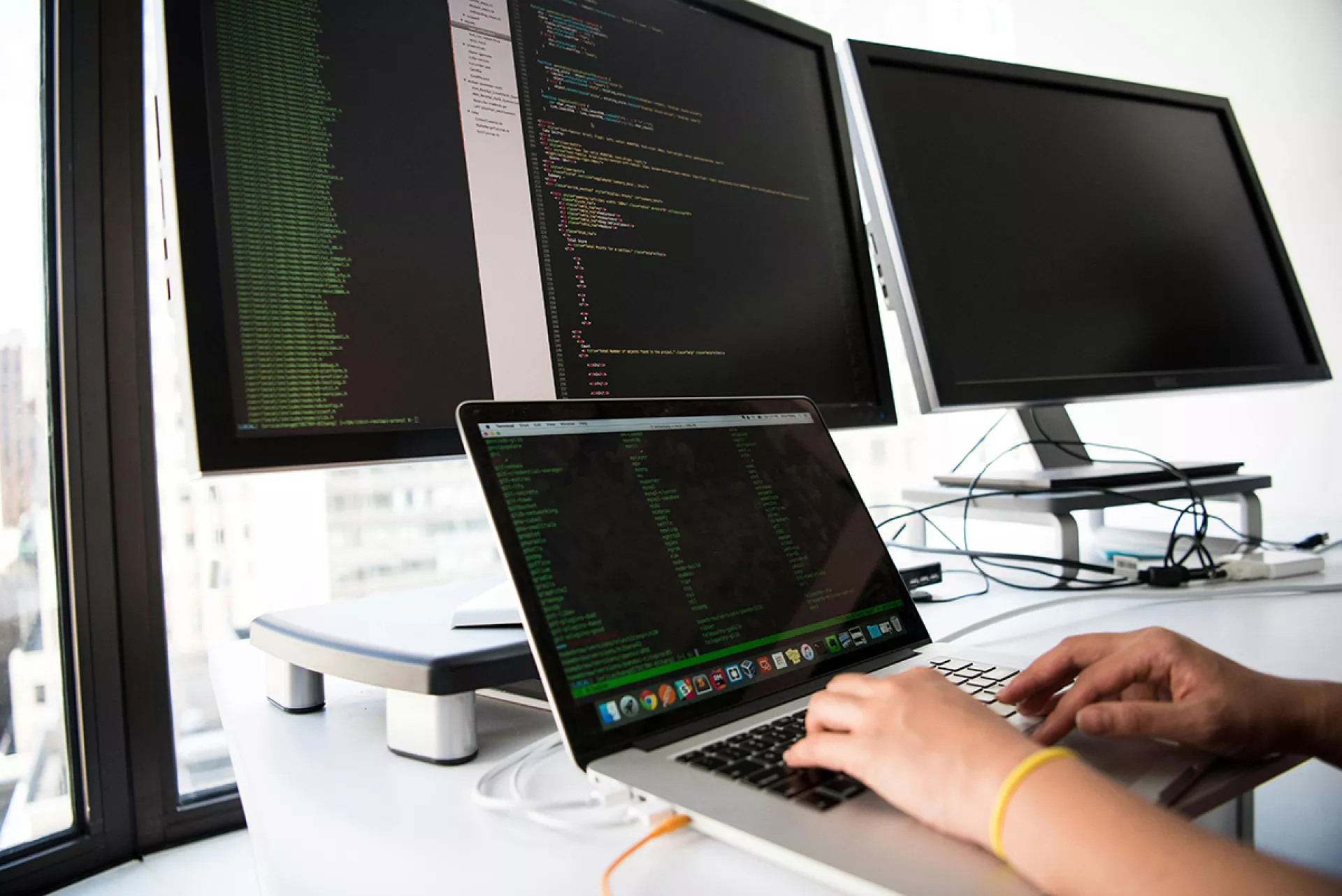 Person typing on laptop and coding