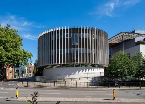 Swiss Cottage, circular building with vertical slats under a clear blue sky.